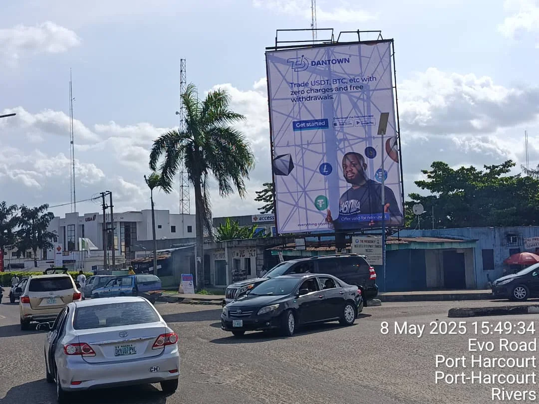 A roadside campaign billboard photographed from the street