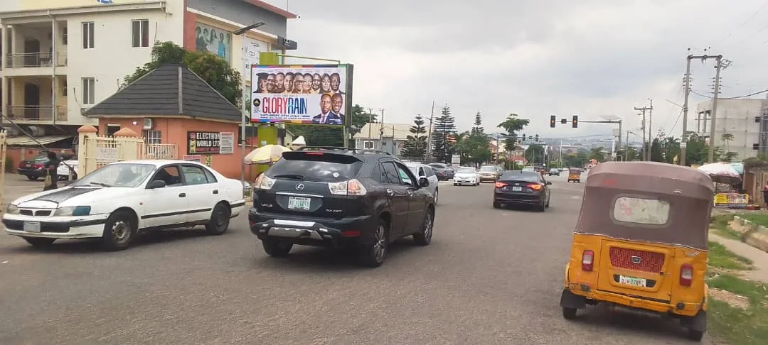 A roadside campaign billboard install with passing traffic
